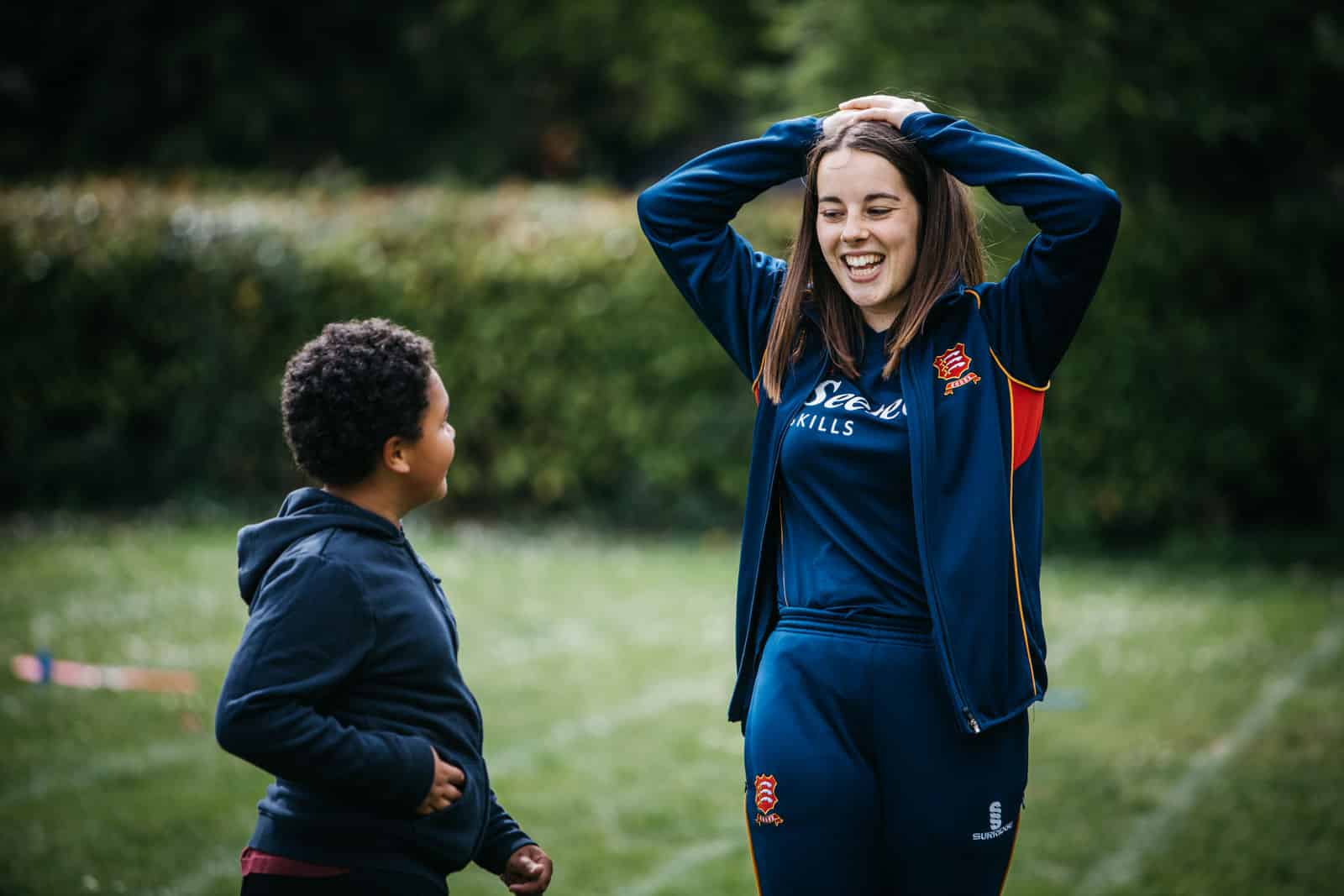 Coach Core image of young female coach laughing with younger participant