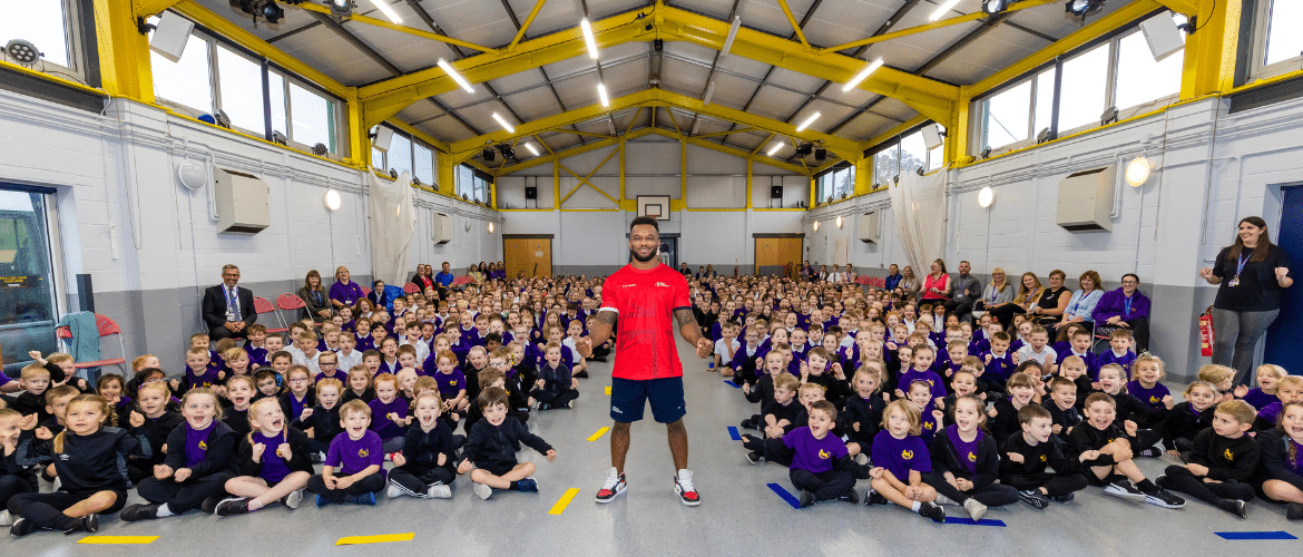 Courtney with pupils at a school