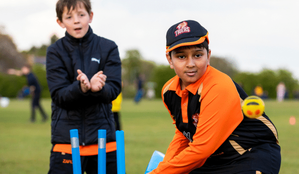 2 boys playing cricket